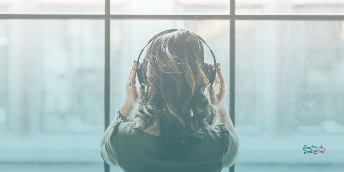 woman with earphones looking out window